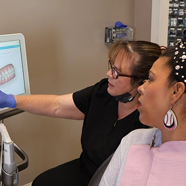 Dental assistant reviewing a digital scan at Singing River Dentistry.