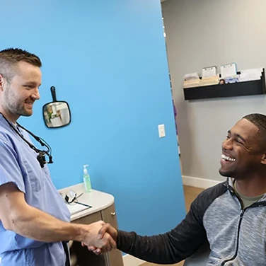 Dr. Petersen shaking a patient's hand.