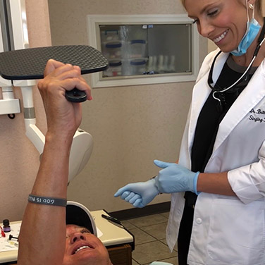Dr. Brittany Westerman showing a patient his beautiful, clean smile