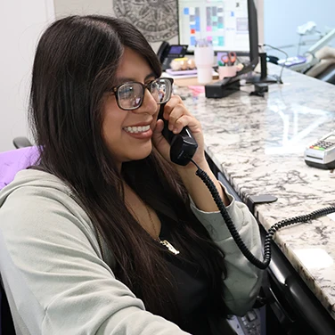 Smiling receptionist at Singing River Dentistry in Russellville.