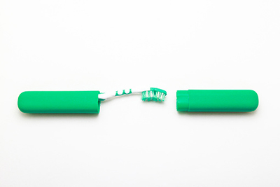 image of a green travel toothbrush