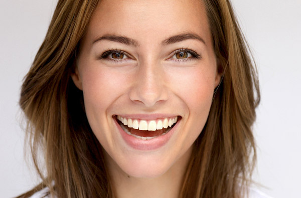 Woman smiling after getting cosmetic dental treatment at Singing River Dentistry in Muscle Shoals, AL