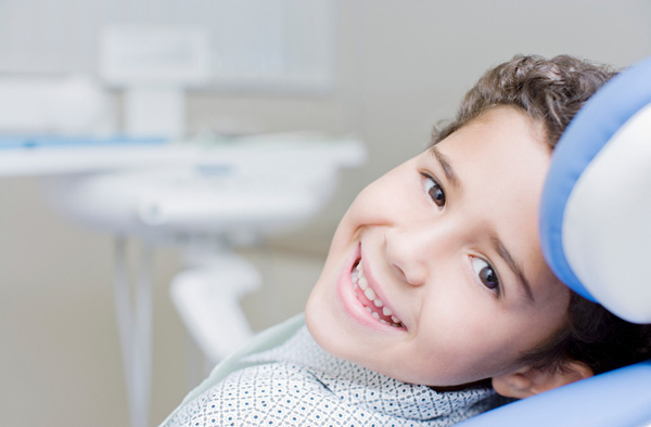 Young boy smiling after getting dental sealants at Singing River Dentistry in Muscle Shoals, AL 