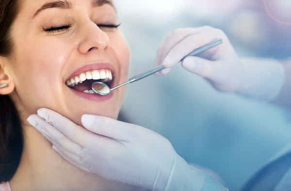 Woman getting dental exam at Singing River Dentistry in Russellville, AL