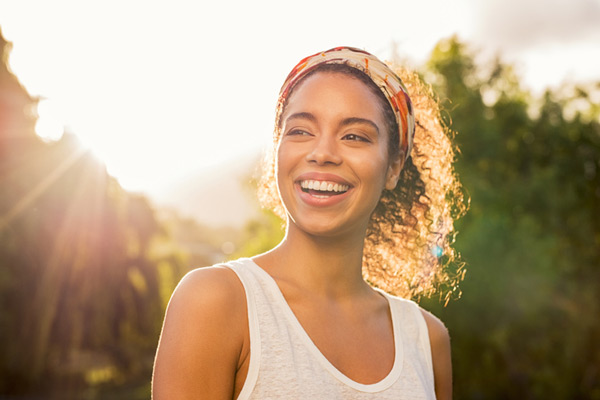 beautiful woman outside smiling in the sunlight