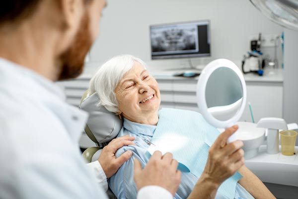 Elderly woman enjoying her new smile at Singing River Dentistry in Muscle Shoals AL 35661 