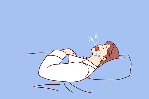 A man snoring while lying in bed, showing airflow disruption typically associated with sleep apnea.